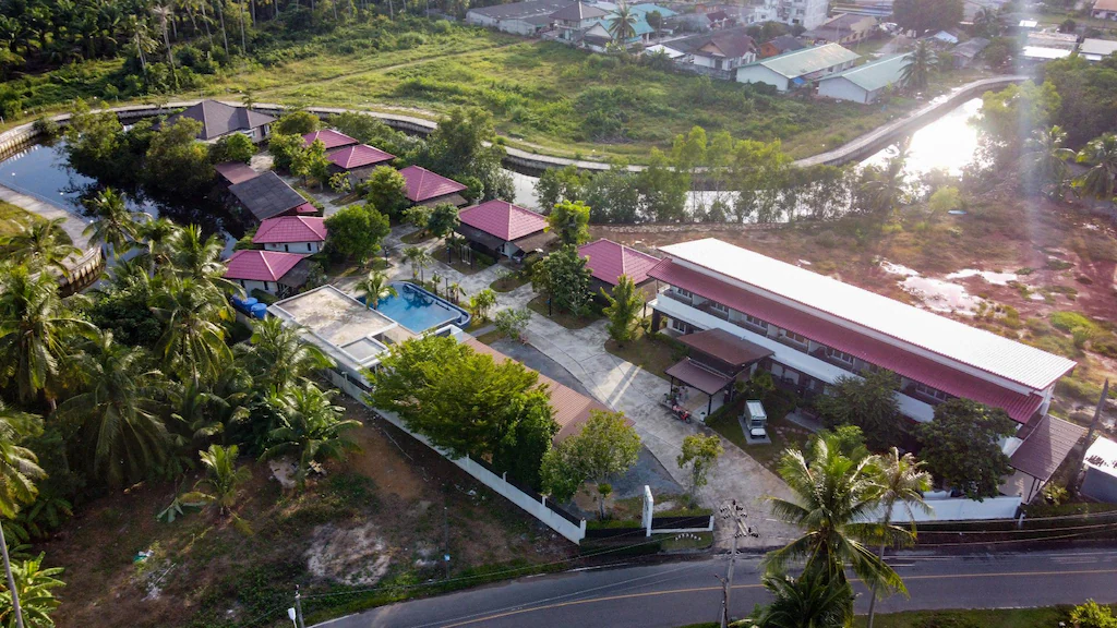 The raspberry villa surrounded by banana palms and jungle
